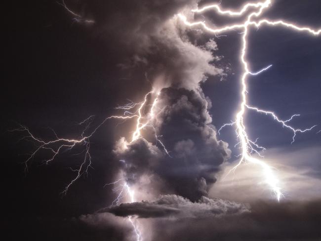 Lightning strikes as a column of ash surrounds the crater of Taal Volcano. Picture: Getty