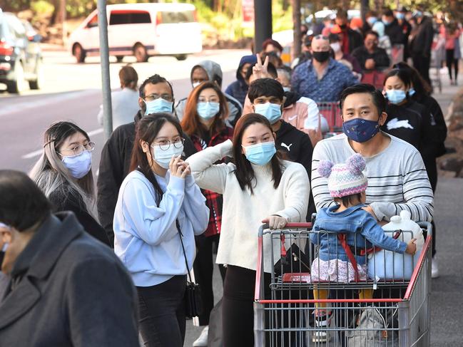 Shoppers wait in a long queue outside a Costco outlet in Melbourne yesterday. Picture: AFP