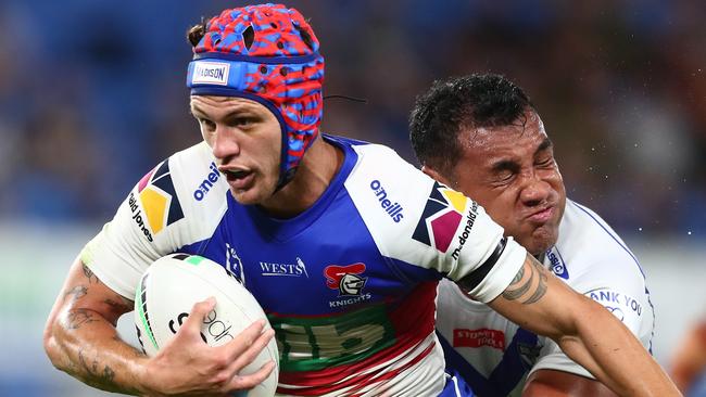 GOLD COAST, AUSTRALIA – AUGUST 21: Kalyn Ponga of the Knights is tackled during the round 23 NRL match between the Canterbury Bulldogs and the Newcastle Knights at Cbus Super Stadium, on August 21, 2021, in Gold Coast, Australia. (Photo by Chris Hyde/Getty Images)