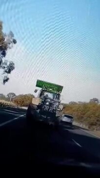 Dashcam footage of couple driving alleged stolen tractor on Goulburn Valley Highway