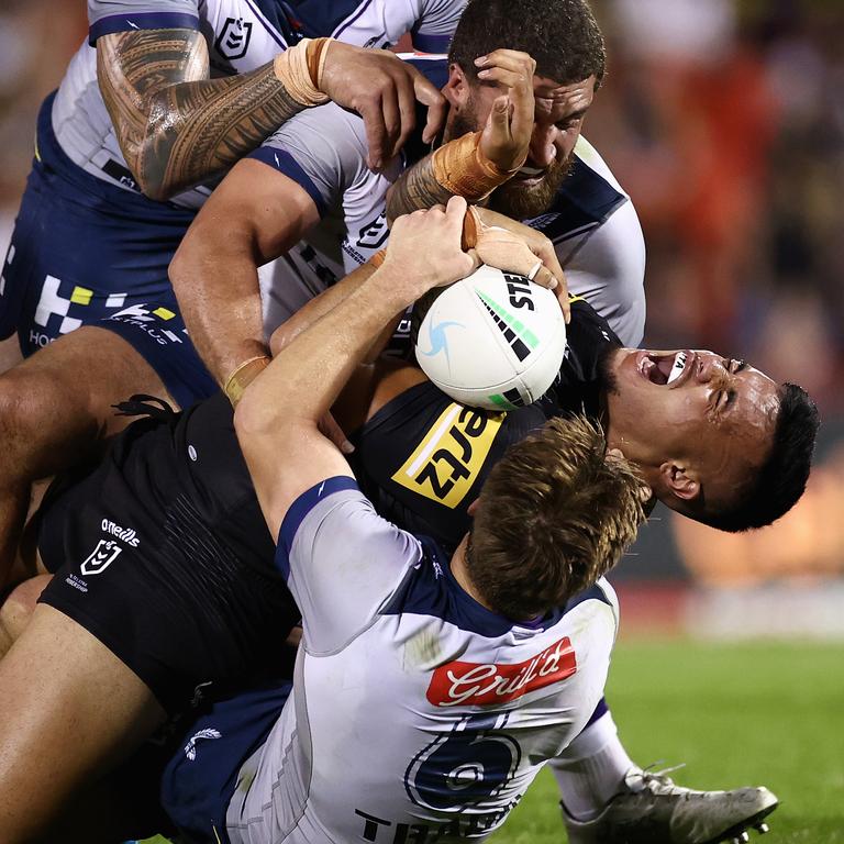 Spencer Leniu of the Pantherscries out as Cameron Munster drops down onto the back of his leg in a tackle. Picture: Cameron Spencer/Getty Images