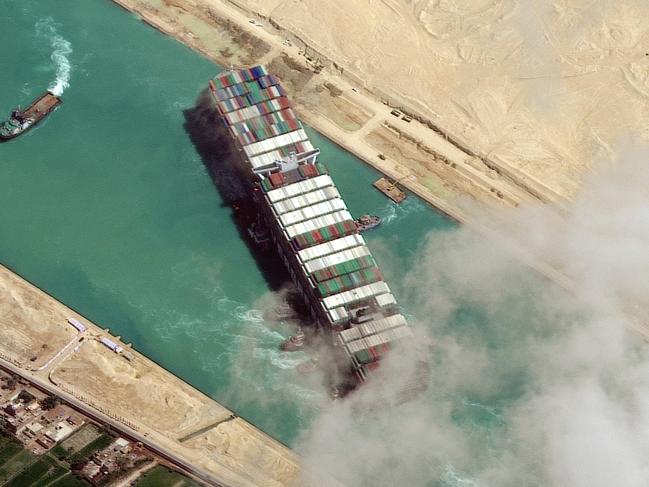 This satellite imagery released by Maxar Technologies shows the MV Ever Given container ship being pushed by tugboats in the Suez Canal on March 29, 2021. - The MV Ever Given was refloated and the Suez Canal reopened on March 29, 2021, sparking relief almost a week after the huge container ship got stuck during a sandstorm and blocked a major artery for global trade. AFP correspondents observed tugboat crews sounding their foghorns in celebration after the Ever Given, a cargo megaship the length of four football fields, was dislodged from the banks of the Suez. (Photo by - / Satellite image Â©2021 Maxar Technologies / AFP) / RESTRICTED TO EDITORIAL USE - MANDATORY CREDIT "AFP PHOTO / Satellite image Â©2021 Maxar Technologies" - NO MARKETING - NO ADVERTISING CAMPAIGNS - DISTRIBUTED AS A SERVICE TO CLIENTS