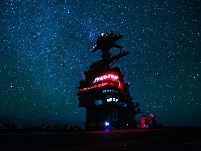 Aircraft carrier USS Gerald R. Ford as it transits the Atlantic Ocean at night. The US Navy is teaching sailors how to navigate by the stars with the help of sextants, first used in the 18th century. Picture: Joshua Sheppard