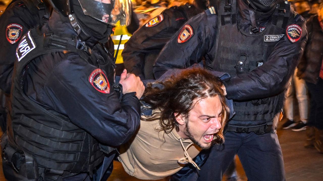 Police officers detain a man following calls to protest against partial mobilisation. Picture: Alexander Nemenov/AFP