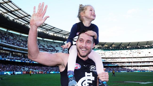 Dale Thomas savours Carlton’s win with daughter Matilda after announcing his retirement during the week. Picture: AAP