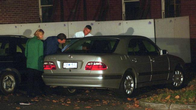 Police look at a Mercedes Benz car dumped in Middle Park.