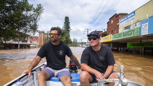 Anyone with a boat became a rescuer, including neighbours Toby Collings and Beau Weekes. Picture: Media Mode