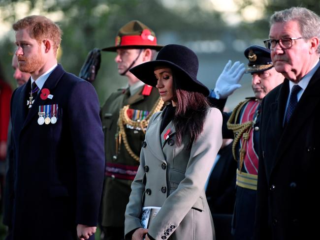 Prince Harry and Meghan Markle with Alexander Downer at the Dawn Service. Picture: Reuters/Toby Melville