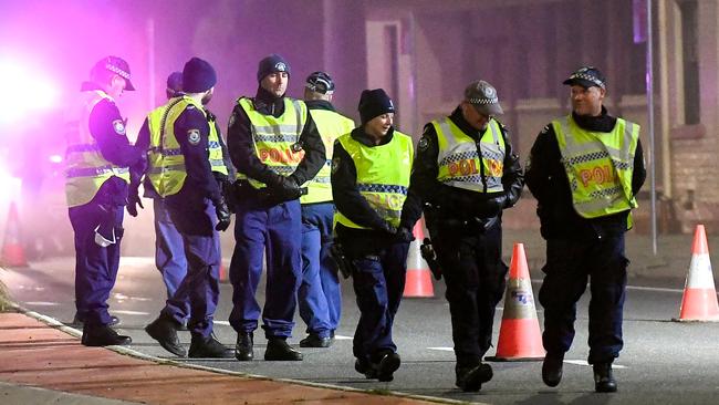 Police begin patrols in Albury after the border was closed at midnight. Picture: AFP