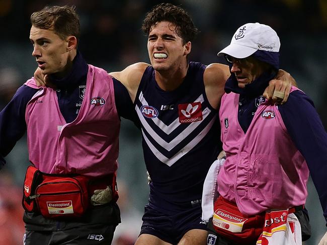 PERTH, WESTERN AUSTRALIA - MAY 21:  Alex Pearce of the Dockers is assisted off the field during the round nine AFL match between the Fremantle Dockers and the Richmond Tigers at Domain Stadium on May 21, 2016 in Perth, Australia.  (Photo by Will Russell/AFL Media/Getty Images)