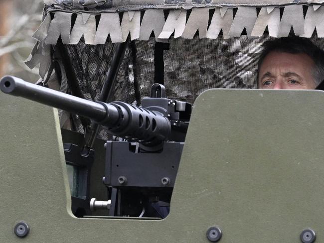 King Frederik X of Denmark peeks out of the turret on the top of the Patria 6x6 vehicle in Finland. Picture: AFP / Finland OUT