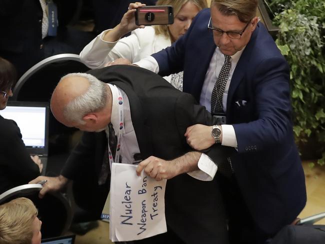 American writer and political activist Sam Husseini argues with a security staffer prior to the press conference. Picture: AP.