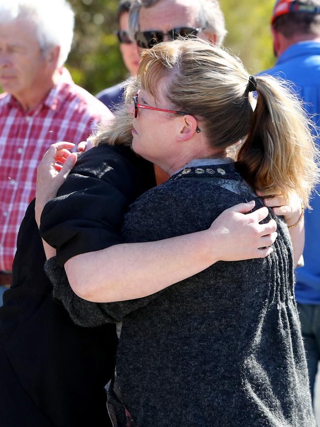 <s1>Sarah Vandepeer is consoled by a friend as the search continues at Granite Beach.</s1> Picture: Simon Cross