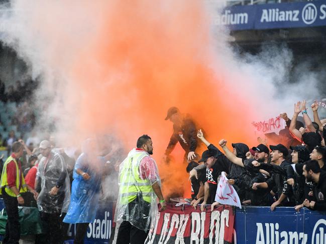 Members of the Wanderers supporting group Red and Black Bloc (RBB) react after Oriol Riera of the Wanderers scored a goal during the round 21 A-League match between Sydney FC and the Western Sydney Wanderers at Allianz Stadium in Sydney, Sunday, February 25, 2018. (AAP Image/Brendan Esposito) NO ARCHIVING, EDITORIAL USE ONLY