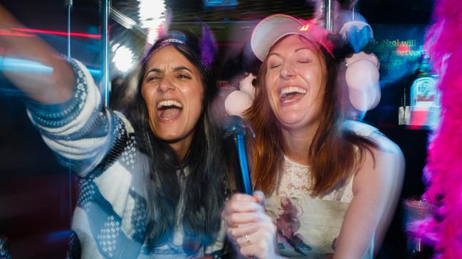 Madeleine Sami (as Mel) and Celia Pacquola (as Anna) on a karaoke party bus in The Breaker Upperers. Picture: Madman