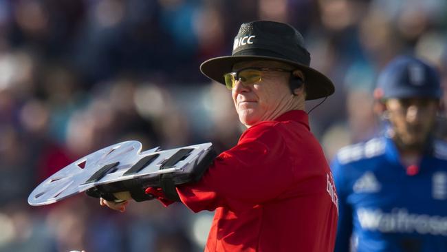 Umpire Bruce Oxenford designed his own forearm shield.