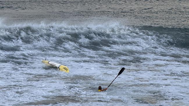 A man was flipped on his surfski before being helped by another ski rider, Grant Kenny, at Mooloolaba on Saturday morning.