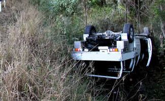 Lucky escape: The driver and passenger of this ute were treated at hospital after running off the Pacific Highway at Moonee. Picture: Frank Redward