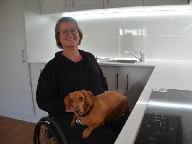 Asti Savage and her dog Jag show off a Elliot Springs home built to NDIS 'high physical support' spec - designed for those in wheelchairs and powerchairs.