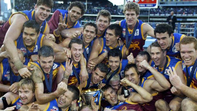 Brisbane players celebrate after winning the 2003 Grand Final.