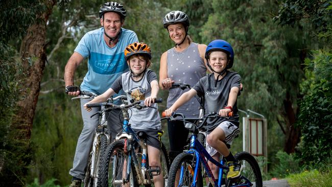 Scott and Fiona Louder take sons Bailey, 10, and Jack, 8, for a ride in Eltham. Pictures: JAKE NOWAKOWSKI