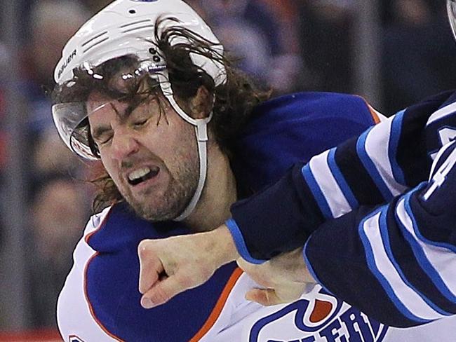 WINNIPEG, MB - DECEMBER 3: Luke Gazdic #20 of the Edmonton Oilers fights with Anthony Peluso #14 of the Winnipeg Jets in second period action in an NHL game at the MTS Centre on December 3, 2014 in Winnipeg, Manitoba, Canada. Marianne Helm/Getty Images/AFP == FOR NEWSPAPERS, INTERNET, TELCOS & TELEVISION USE ONLY ==