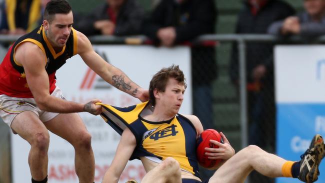 Fitzroy's Jai Burns drags Hurstbridge's Tom Grimes off the ball. Picture: Brendan Francis.