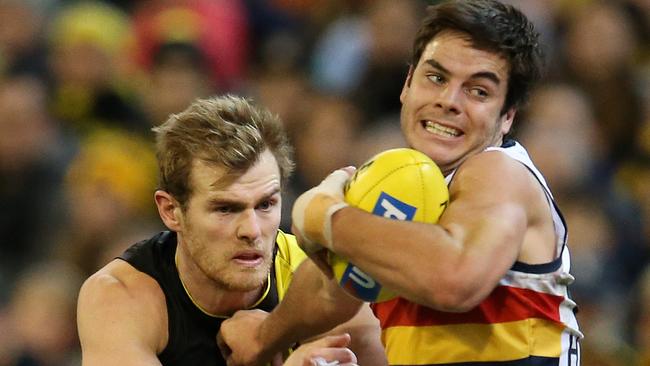 Adelaide's Darcy Fogarty tries to break the tackle of Richmond's David Astbury. Picture: Michael Klein