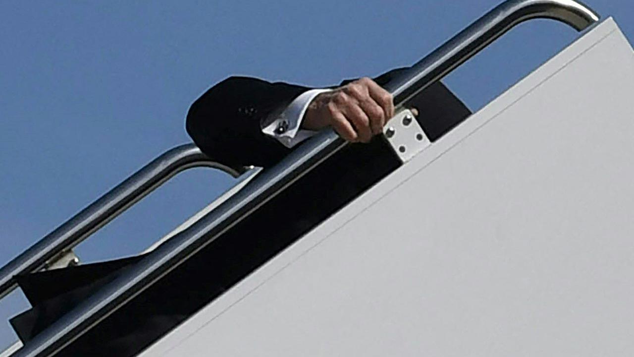 US President Joe Biden trips while boarding Air Force One. Picture: Eric BARADAT / AFP