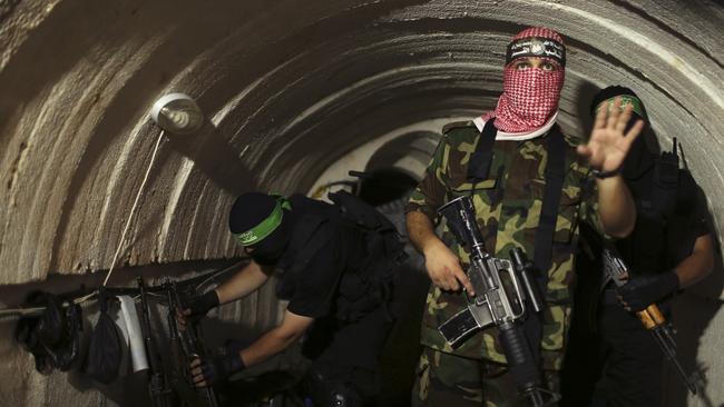 A Palestinian fighter from the Izz el-Deen al-Qassam Brigades, the armed wing of the Hamas movement, gestures inside an underground tunnel in Gaza in 2014. Picture: Reuters