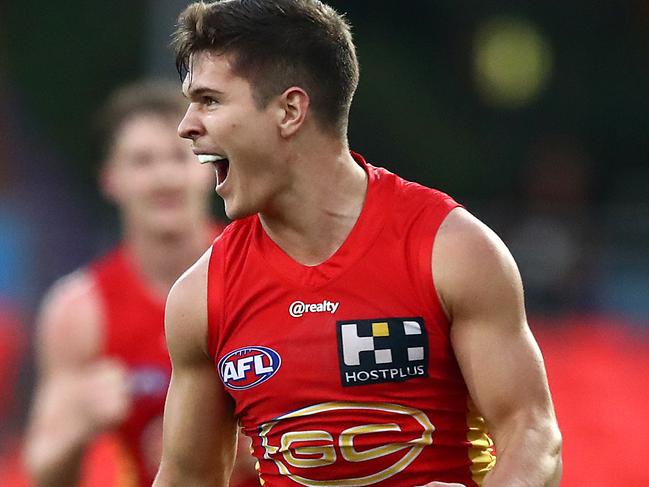 GOLD COAST, AUSTRALIA - JUNE 21: Connor Budarick of the Suns celebrates a goal during the round 3 AFL match between the Gold Coast Suns and the Adelaide Crows at Metricon Stadium on June 21, 2020 in Gold Coast, Australia. (Photo by Jono Searle/AFL Photos/via Getty Images )