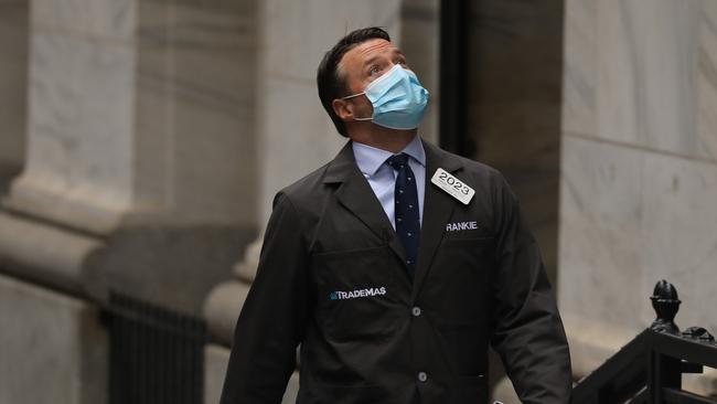 A trader arrives at the New York Stock Exchange for the reopening of the trading floor. Picture: AFP