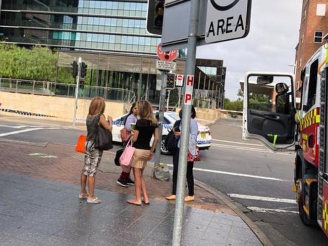 People on the street during the police operation at the intersection of George and Marsden Street. Picture: Snow Queen J / Twitter.