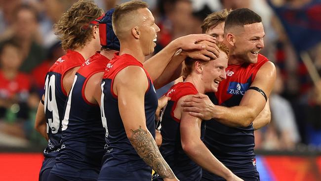 Jake Bowey’s teammates rally around him after his kicked his first goal in the AFL against the Bulldogs in round 1. Picture: Getty Images