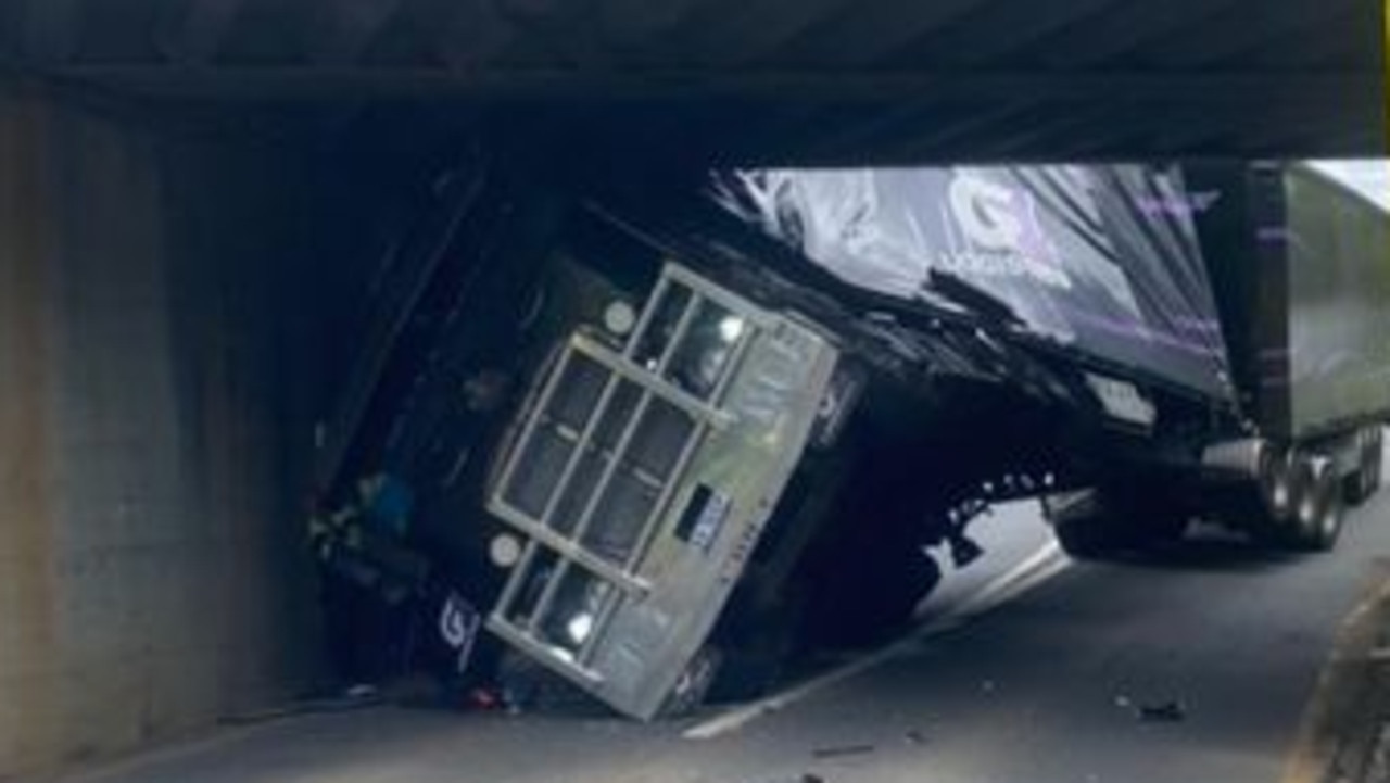 Traffic chaos as B-double wedged under rail bridge