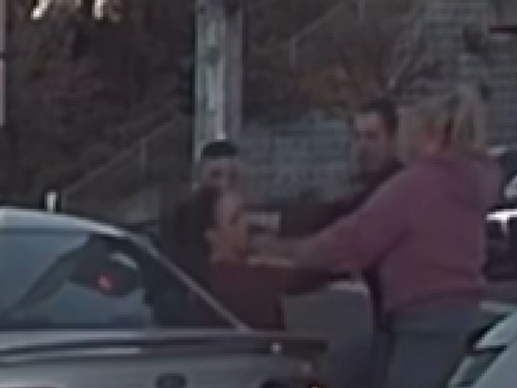 The first man grabs the driver by the shirt while his female partner dressed in a pink top starts to scuffle with the woman, who appeared to attempt to stop the fight.