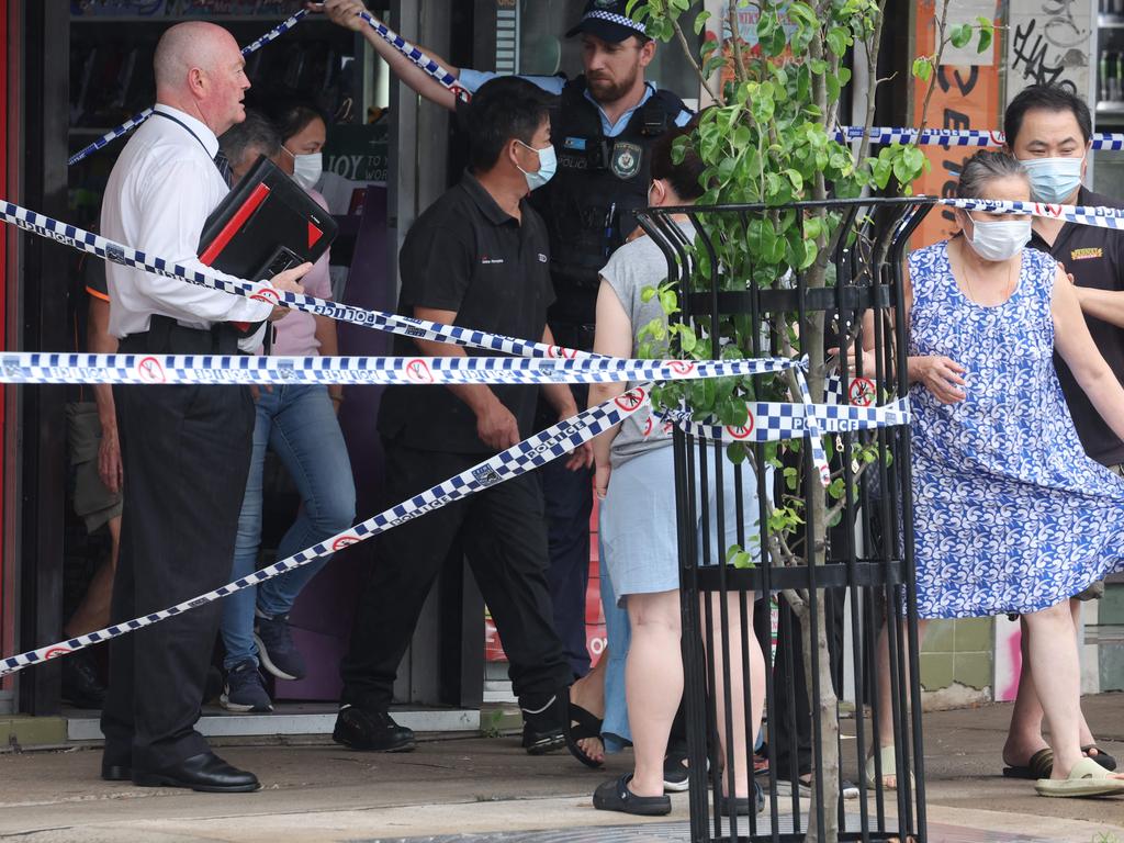 Police escort the family from the scene. Picture: Rohan Kelly.