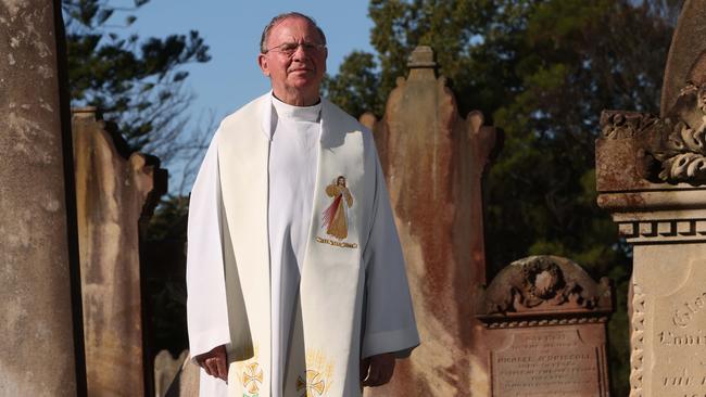 Father Peter Guy at Rookwood cemetery. Picture: Damian Shaw