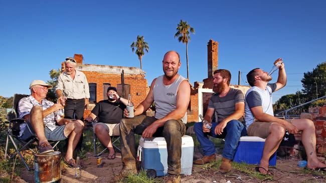 Locals from Eugowra along with two of the new co-owners of the Fat Lamb Hotel gather to enjoy a Friday afternoon beer in the remains of the historic pub.