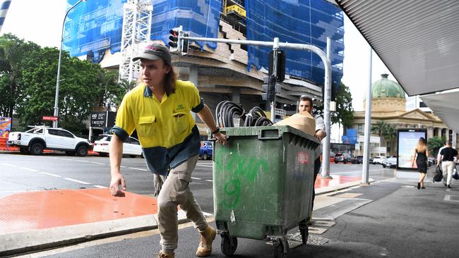 Tradies packing up their gear and leaving the Probuild construction site at 443 Queen St in February.