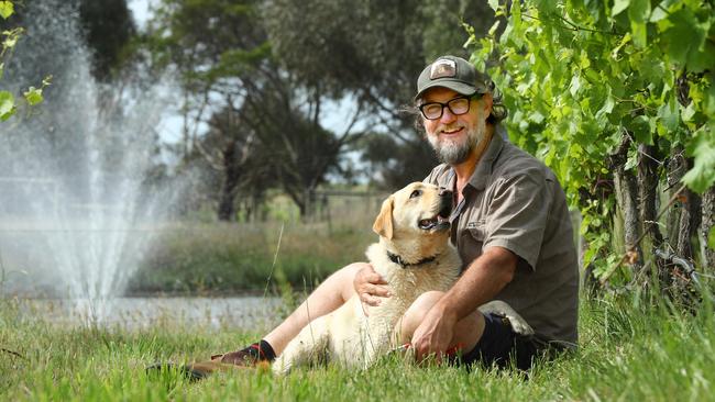 John White is sharing his experience with an uncommon cancer. Pictured at his vineyard, Coatsworth Farm, with dog Frankie. Picture: Alison Wynd