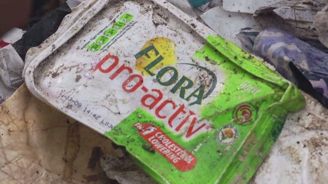 A familiar margarine packet among the mountains of rubbish in a backyard replying facility on China.