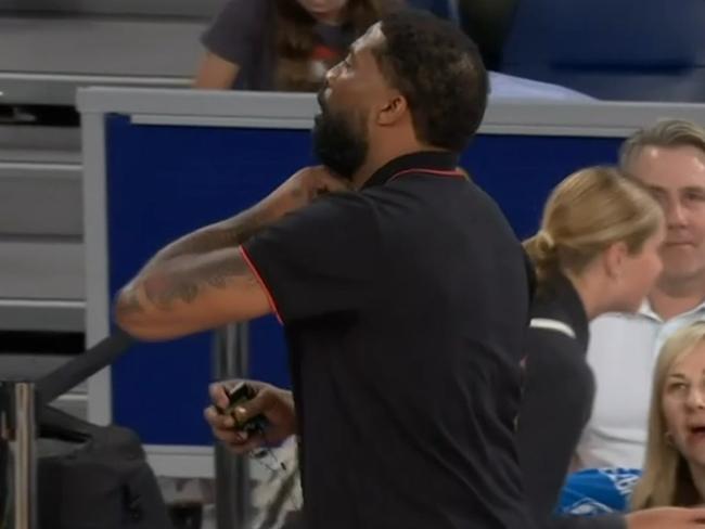 Justin Tatum removes his live mic during the clash with Melbourne United. Picture: ESPN