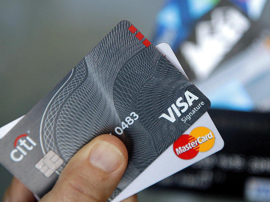 FILE - In this June 15, 2017, file photo, credit cards are displayed in Haverhill, Mass. Focus on simple money-saving moves in 2019. Sign up for a credit card that pays you back. Pick one that gives you cash back for specific purchases or a general card that rewards you for all your purchases. (AP Photo/Elise Amendola, File)