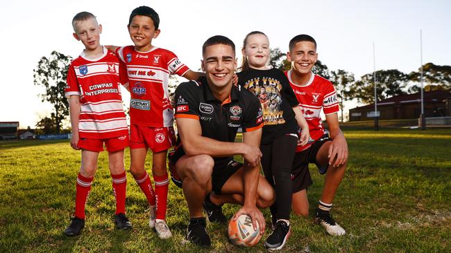 King of the kids: Wests Tigers player Tallyn Da Silva returns to his junior ground at Waminda Oval before his first grade debut. L-R East Campbelltown juniors Izayah Tutton and Moustapha Moussa along with Tallyn’s sister Peyton and brother Kyle. Picture: Richard Dobson