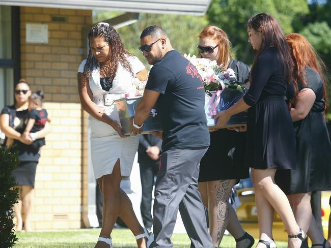 Carrying her daughter’s tiny silver coffin, Helena Tauaifaga leads mourners at the funeral for Tateolena on Saturday. Picture: Bradley Hunter