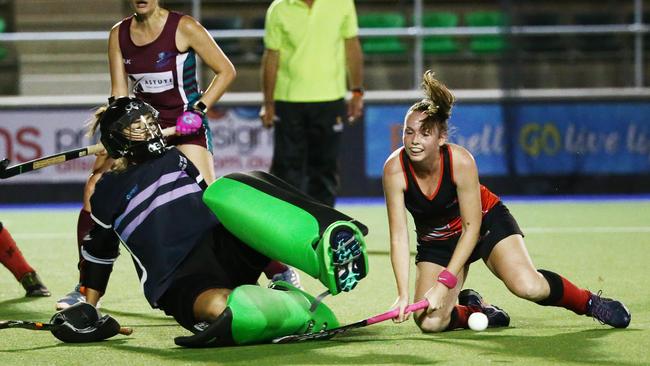 Action from Cairns Hockey A Grade Women's match between Brothers and Souths. Brothers goal keeper Mila Arrotea stops Souths' Caitlyn Whipp's shot at goal. PICTURE: BRENDAN RADKE