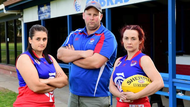 Cove women’s footballers Josie Smith, coach Brett Baldey and captain Dana O'Brien outside the Cove Football Club. Picture: Mark Brake