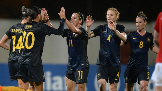 Australian players celebrate after scoring a goal to move ahead of Norway.