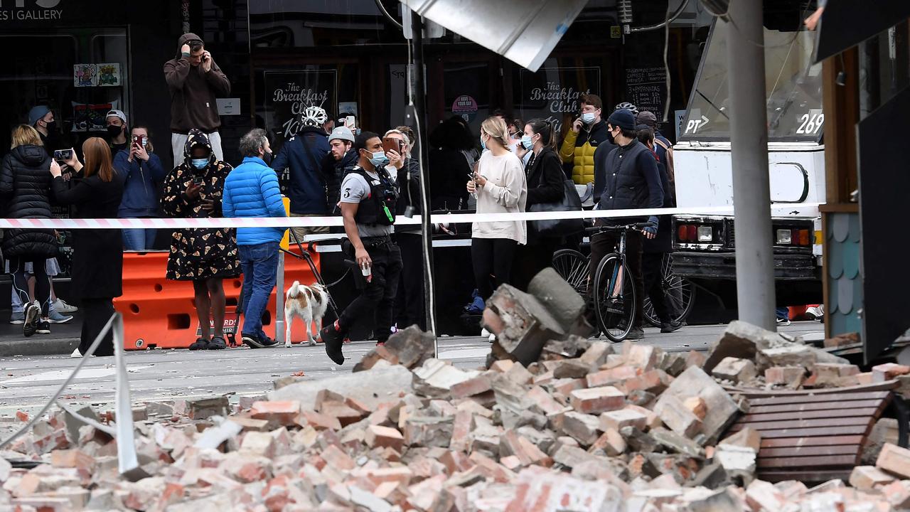 Residents and media gather near the damaged building on Chapel St.